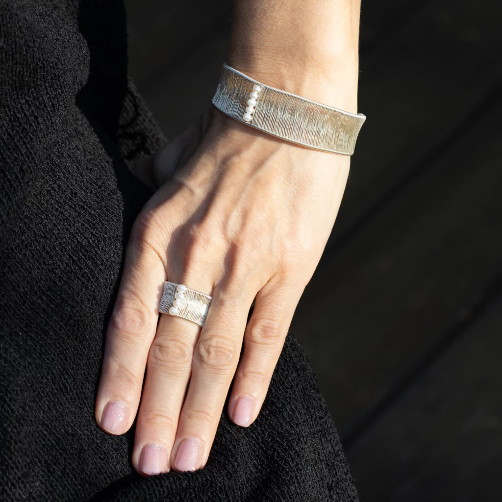 Srebrna bransoletka z kolekcji Alto z perłami, na modelce.