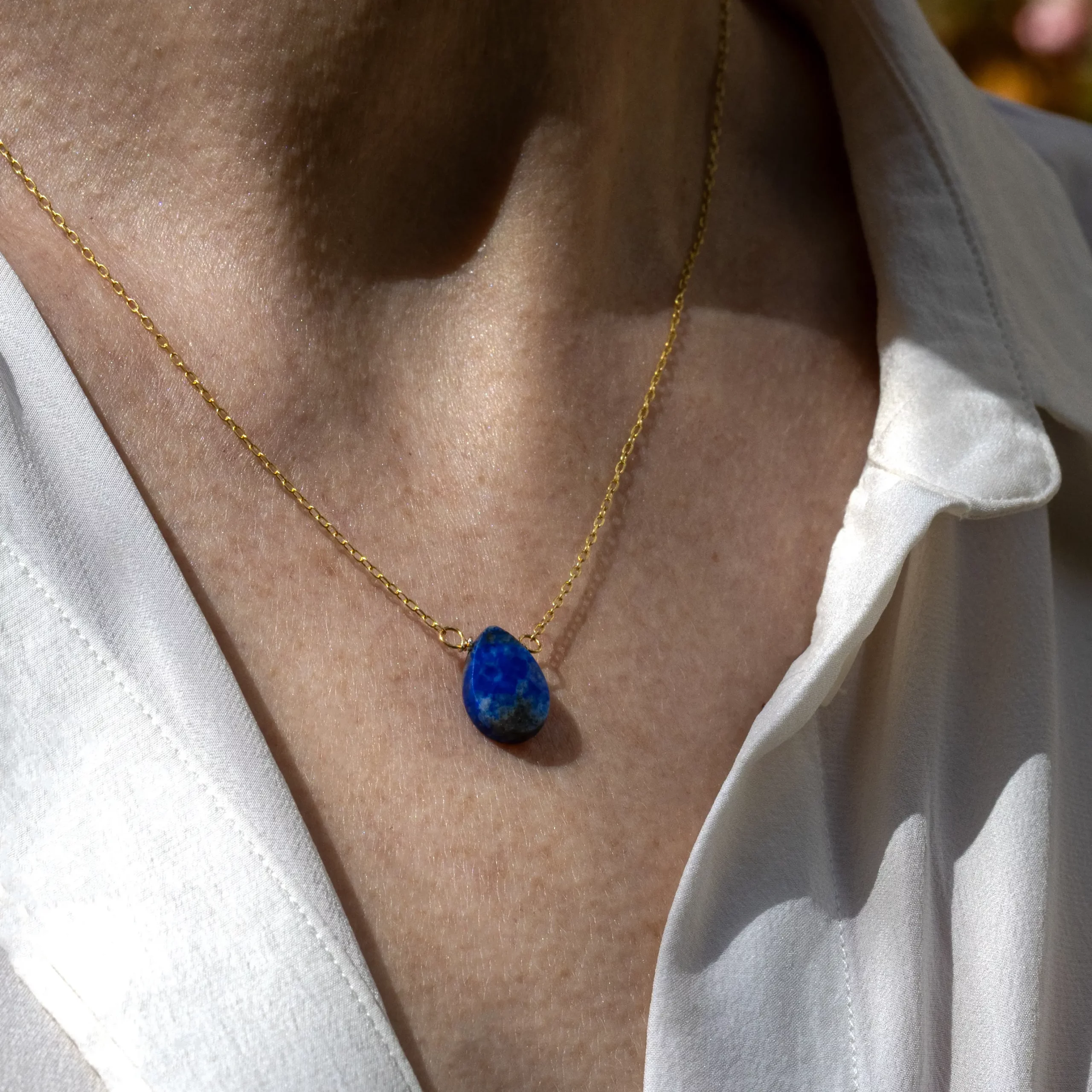 Zbliżenie na naszyjnik Puro z lapisem lazuli, na modelce.